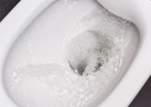 lose-up of a toilet running nonstop after flush, plumbing tips and repair by Trade Pro Plumbing