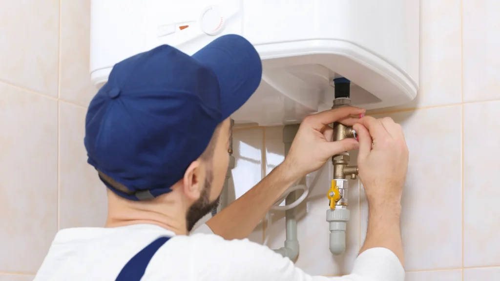 Plumber repairing wall-mounted water heater